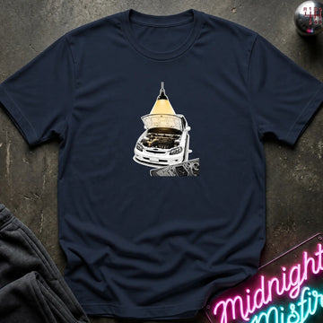 A navy blue short-sleeve t-shirt laid flat on a dark textured surface, featuring a graphic print of a white car with its hood open under a glowing yellow lamp.