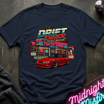 A navy short-sleeve graphic T-shirt laid flat on a dark textured surface. The shirt features a colorful retro diner illustration with the text 'NEO DRIFT DINER' and 'TOKYO DINER,' plus a red sports car graphic.