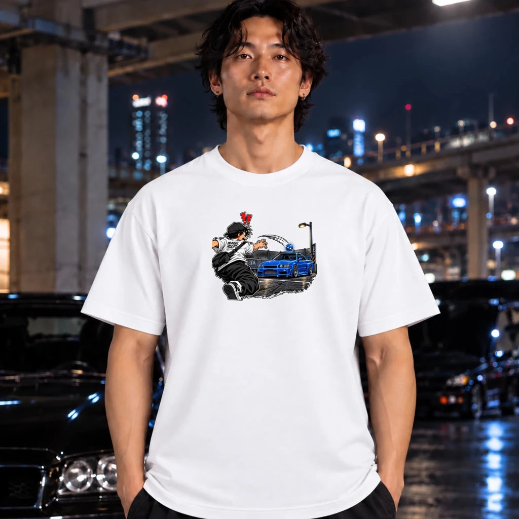 man wearing a white t-shirt and the center of the shirt features a graphic print of an anime character in a black and white outfit with a hat, next to a sports car