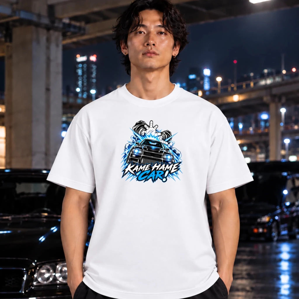 man wearing a white t-shirt. The shirt features a red, white, and black graphic of a car with the text 'KAME HAME CAR!' in stylized lettering.