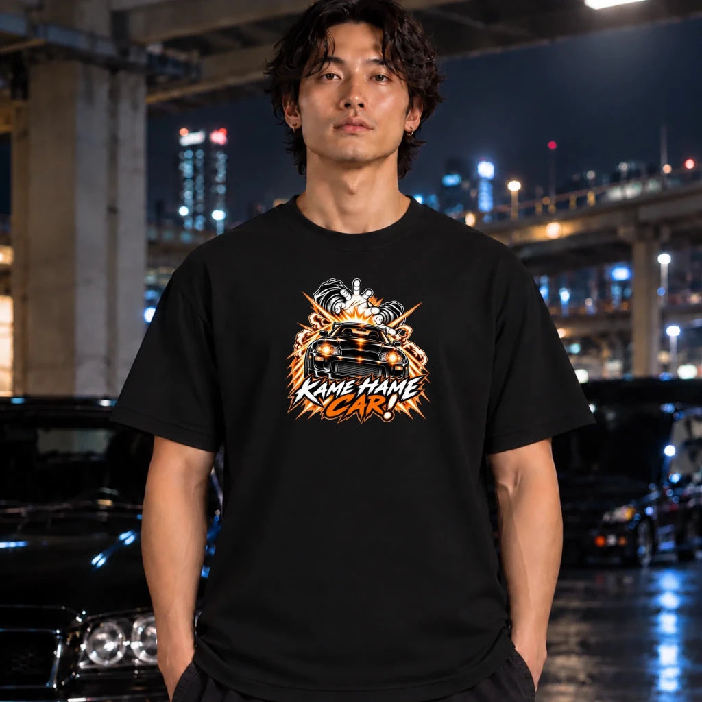 man wearing a black t-shirt. The shirt features a red, white, and black graphic of a car with the text 'KAME HAME CAR!' in stylized lettering.