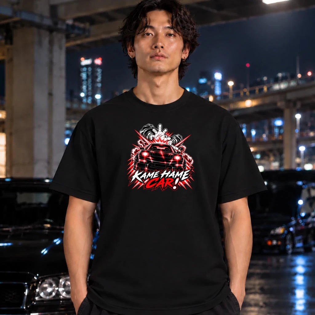 man wearing a black t-shirt. The shirt features a red, white, and black graphic of a car with the text 'KAME HAME CAR!' in stylized lettering.
