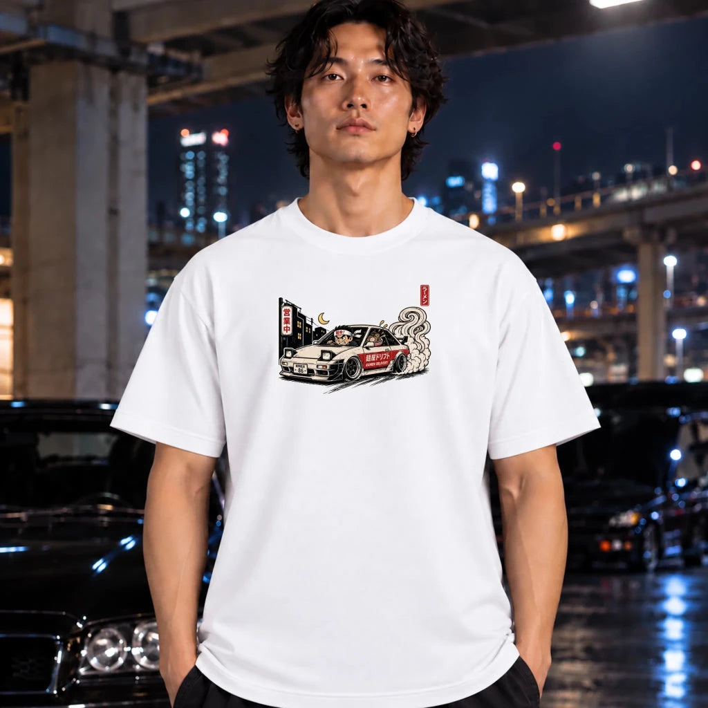 A man wearing white crewneck t-shirt featuring a graphic print of a white sports car with smoke and Japanese text