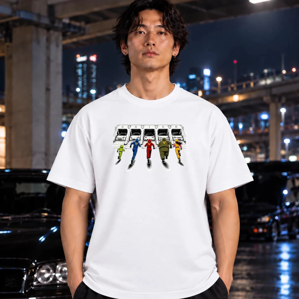 A man wearing a white short-sleeve graphic T-shirt laid flat on a dark textured surface. The shirt features a printed illustration of a white sports cars in 5 different launch pods.