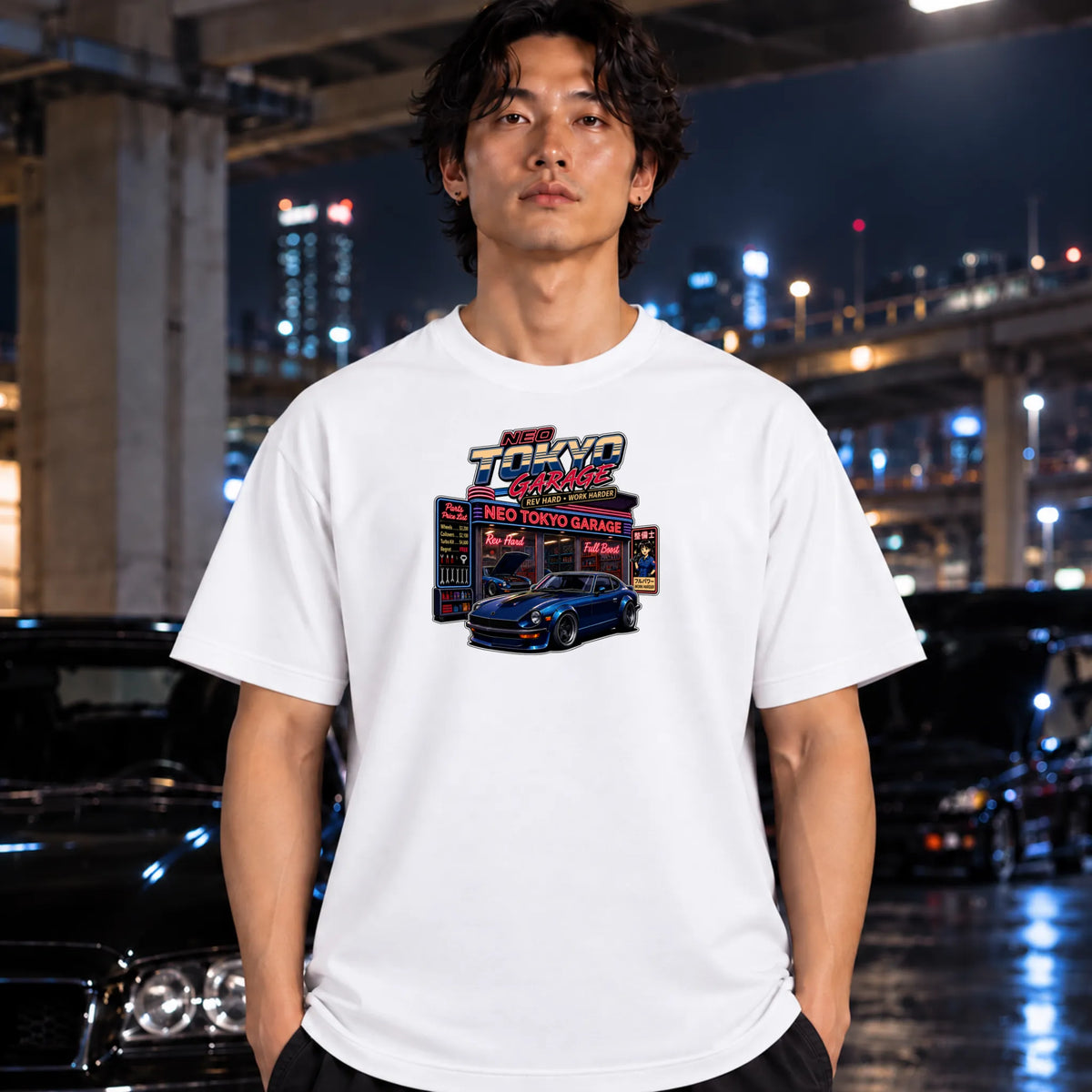 man wearing black crewneck t-shirt featuring a colorful graphic print of a blue sports car in front of a 'Neo Tokyo Garage' sign,