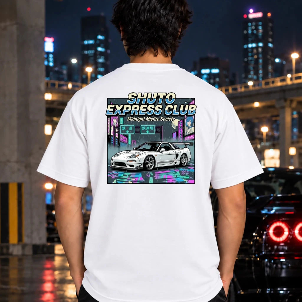 A man viewed from behind wearing a white t-shirt with a large graphic print on the back. The graphic features the text 'SHUTO EXPRESS CLUB' and 'Midnight Misfire Society' above an illustration of a white sports car in a neon-lit cyberpunk city scene.
