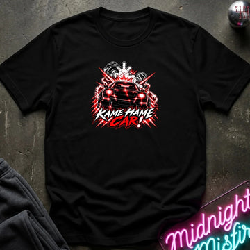 A black short-sleeve graphic t-shirt laid flat on a dark textured surface. The shirt features a red, white, and black graphic of a car with the text 'KAME HAME CAR!' in stylized lettering.