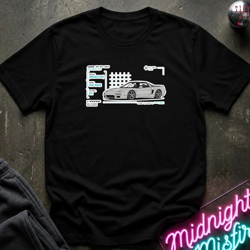 A black short-sleeve t-shirt laid flat on a dark textured surface, featuring a white graphic print of a sports car next to stylized text. 