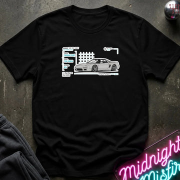 A black short-sleeve t-shirt laid flat on a dark textured surface, featuring a white graphic print of a sports car next to stylized text. 