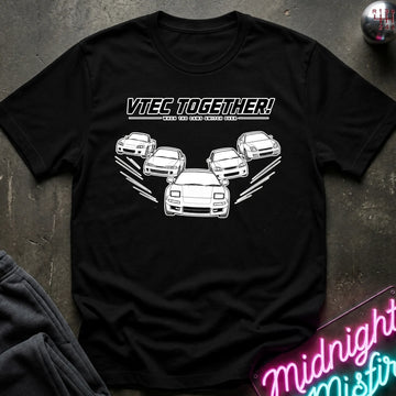 A black short-sleeve graphic T-shirt laid flat on a dark textured surface. The shirt features a white printed design with the text 'VTEC TOGETHER!' and several white car illustrations.
