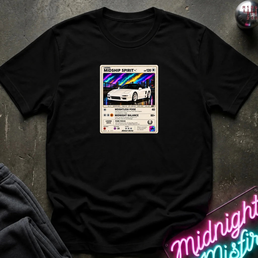 black crewneck t-shirt laid flat on a dark textured surface, featuring a graphic print of vintage card and a car.