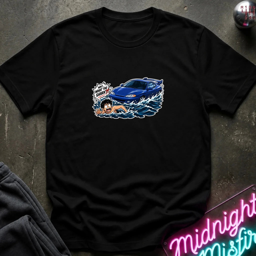 A black short-sleeved t-shirt that has a blue car chasing a swimmer in open water.