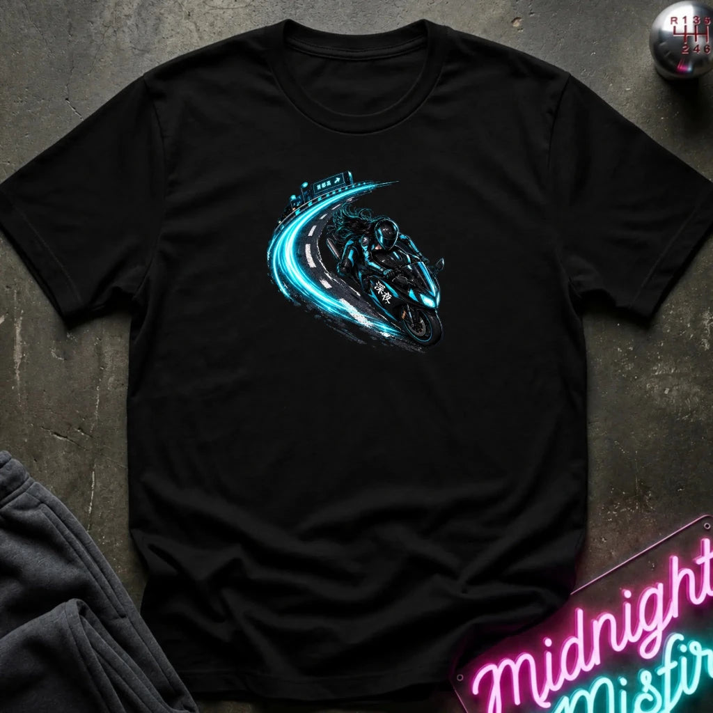 A black short-sleeve t-shirt laid flat on a dark textured surface, featuring a graphic print of a motorcycle riding a glowing blue track. 