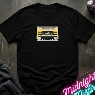 black crewneck t-shirt laid flat on a dark textured surface, featuring a retro cassette tape graphic on the chest with the text 'JDM MIXTAPE VOL.