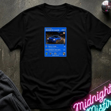 black crewneck t-shirt laid flat on a dark textured surface, featuring a graphic print of vintage card and a car.
