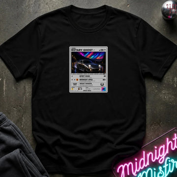 black crewneck t-shirt laid flat on a dark textured surface, featuring a graphic print of vintage card and a car.