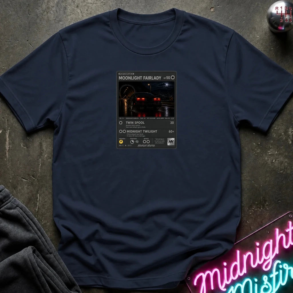 navy crewneck t-shirt laid flat on a dark textured surface, featuring a graphic print of vintage card and a car.