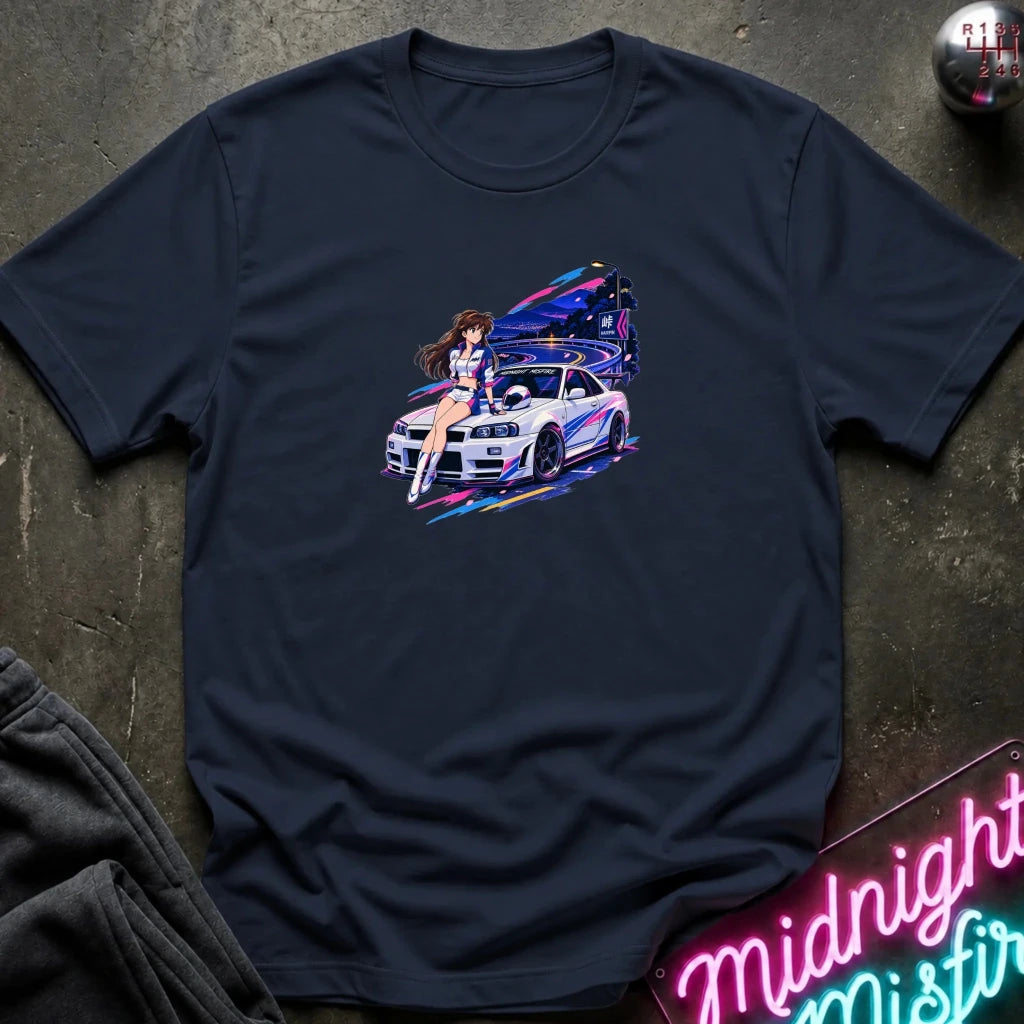 A navy blue  short-sleeve t-shirt laid flat on a dark textured surface, featuring a colorful graphic print of a white sports car and a woman in a neon-lit scene. 