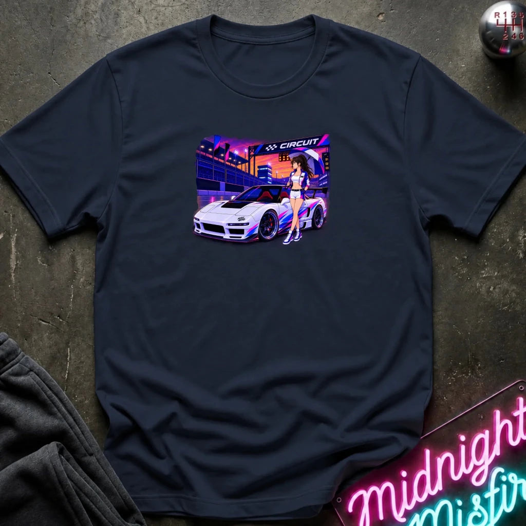 navy short-sleeve t-shirt laid flat on a dark textured surface, featuring a colorful graphic print of a white sports car and a woman in a neon-lit scene. 