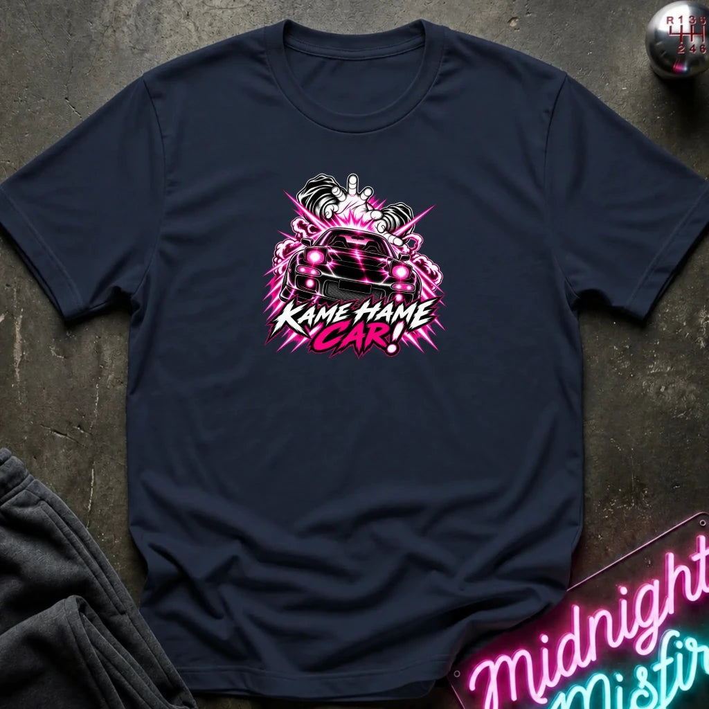 navy short-sleeve graphic t-shirt laid flat on a dark textured surface. The shirt features a red, white, and black graphic of a car with the text 'KAME HAME CAR!' in stylized lettering.