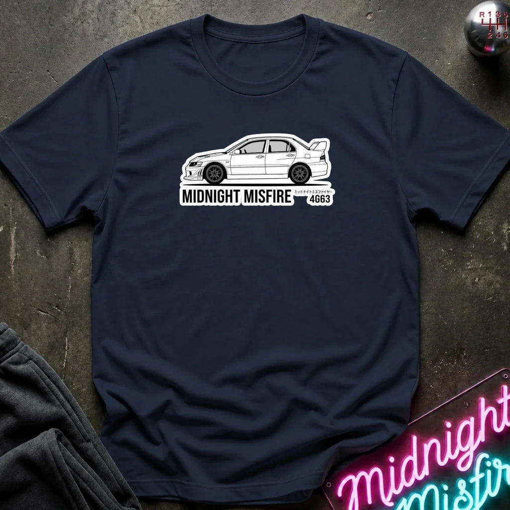 navy short-sleeve t-shirt laid flat on a dark textured surface, featuring a white sports car graphic and the text 'MIDNIGHT MISFIRE '