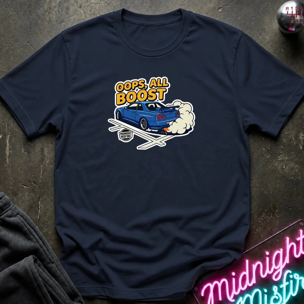 A navy blue crewneck t-shirt laid flat on a dark textured surface. The shirt features a graphic print of a blue sports car with exhaust smoke and the text 'OOPS.