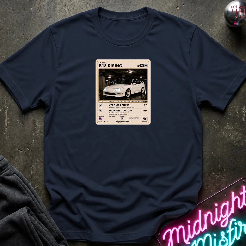 navy crewneck t-shirt laid flat on a dark textured surface. The shirt features a graphic print styled like a retro card