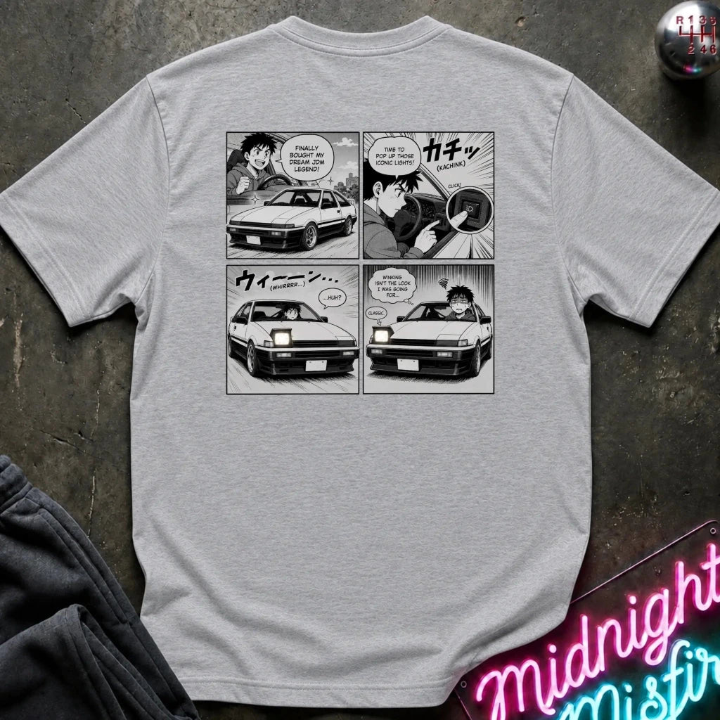 A light gray heather short-sleeve graphic t-shirt featuring a black and white manga comic print showing the headlight winking.