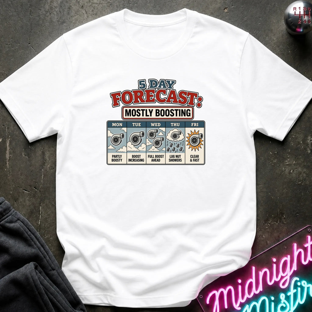 A white short-sleeve graphic T-shirt laid flat on a dark textured surface. The shirt features a colorful '3 Day Forecast: Mostly Boosting' print with weather icons and text for Monday through Friday.