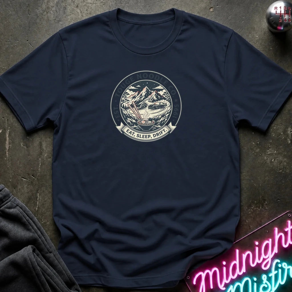 A navy blue crewneck t-shirt with a circular vintage-style graphic on the chest depicting a mountain 