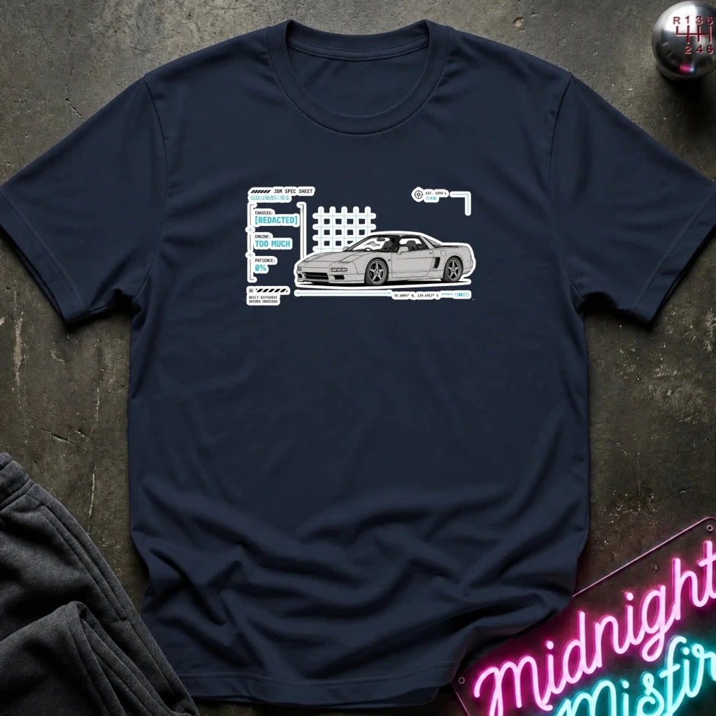 A navy blue short-sleeve t-shirt laid flat on a dark textured surface, featuring a white and gray graphic of a sports car next to stylized text. 
