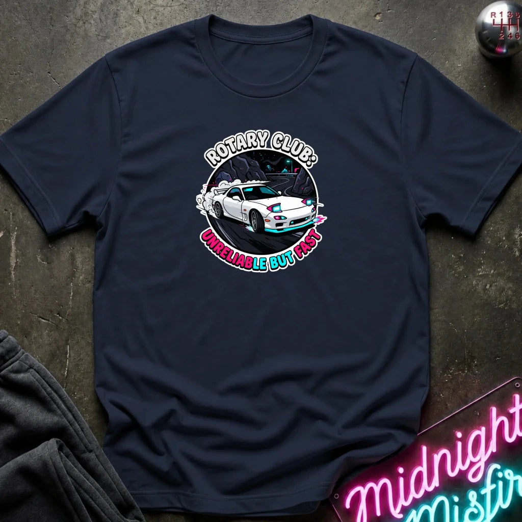 navy crewneck t-shirt laid flat on a dark textured surface. The shirt features a circular graphic print in the center showing a white sports car with blue and pink accents, surrounded by the text 'ROTARY CLUB!