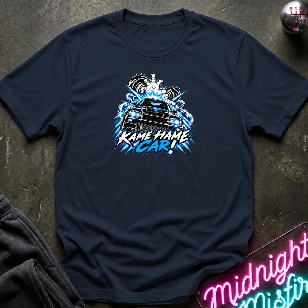 navy short-sleeve graphic t-shirt laid flat on a dark textured surface. The shirt features a red, white, and black graphic of a car with the text 'KAME HAME CAR!' in stylized lettering.