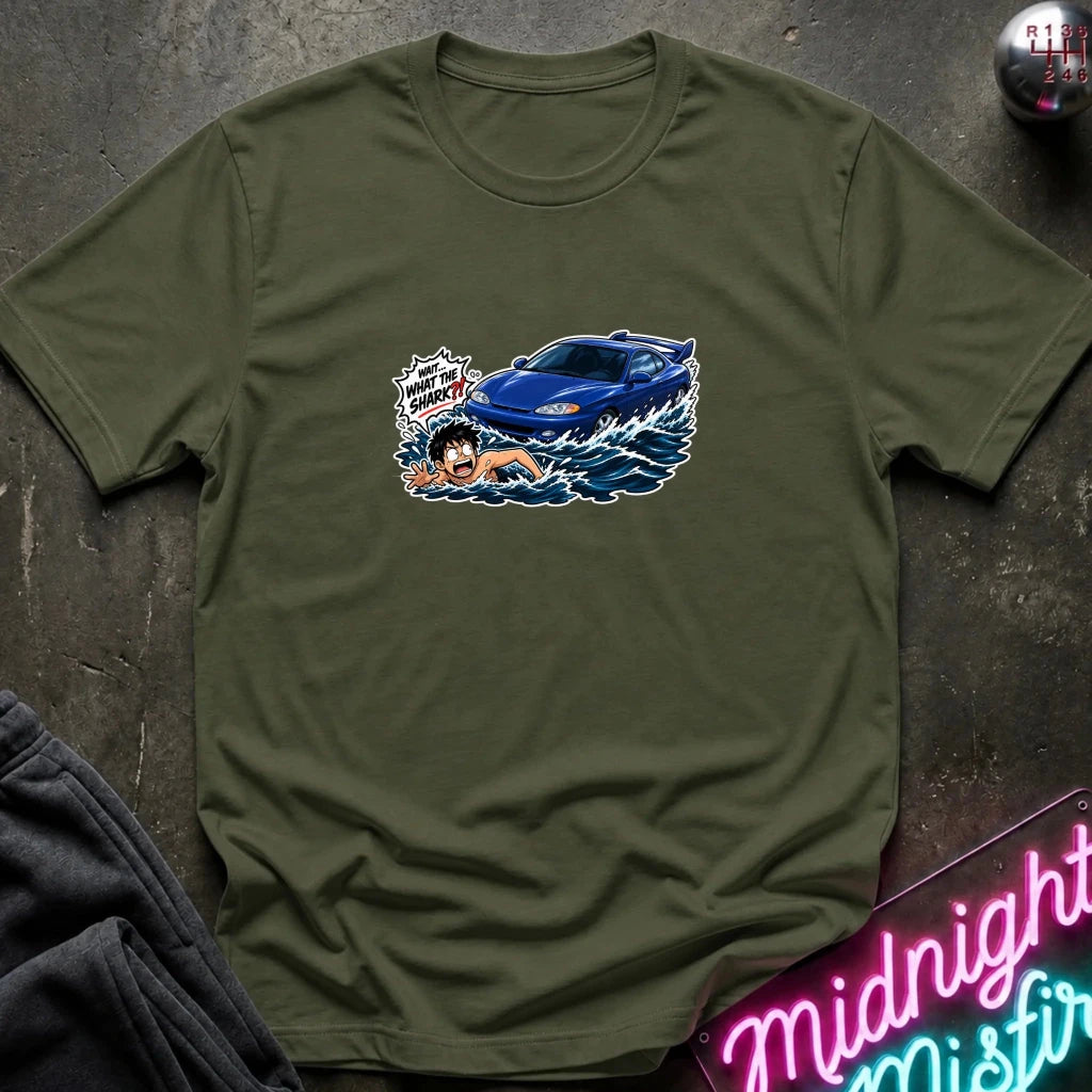 A olive green short-sleeved t-shirt that has a blue car chasing a swimmer in open water.