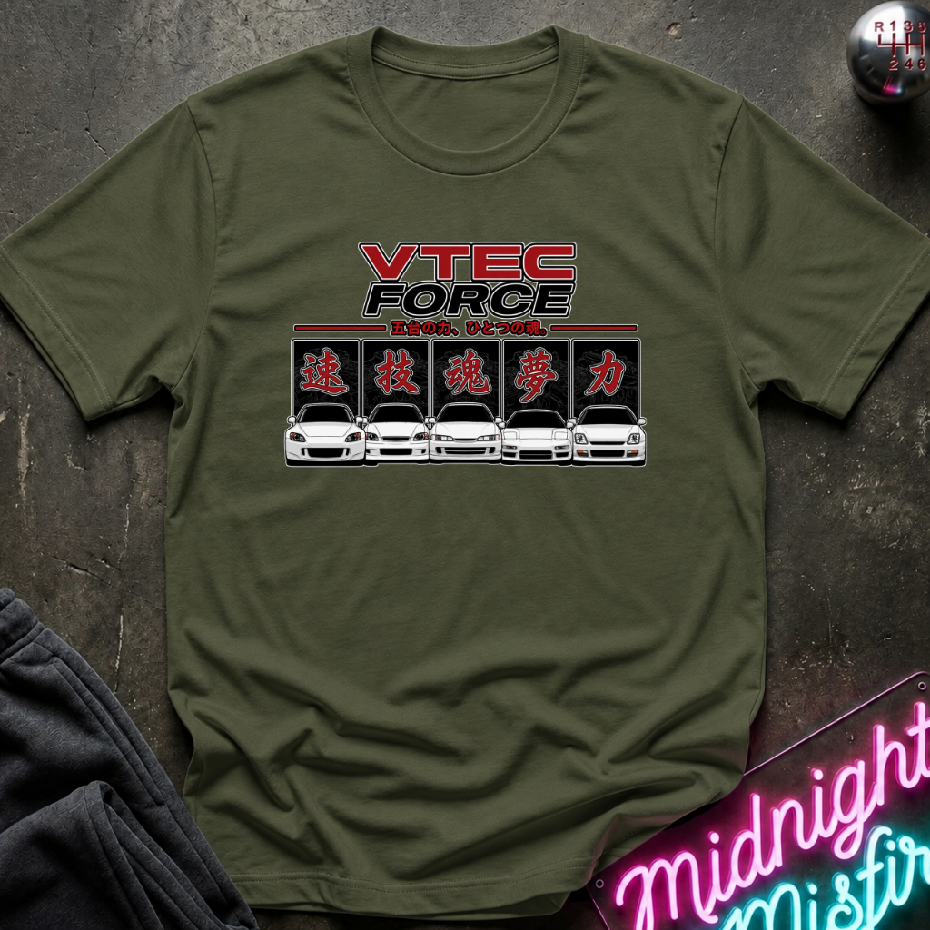 An olive green short-sleeve t-shirt with a 'VTEC FORCE' car graphic printed on the chest, laid flat on a dark textured surface with a neon sign and dark fabric in the corners.