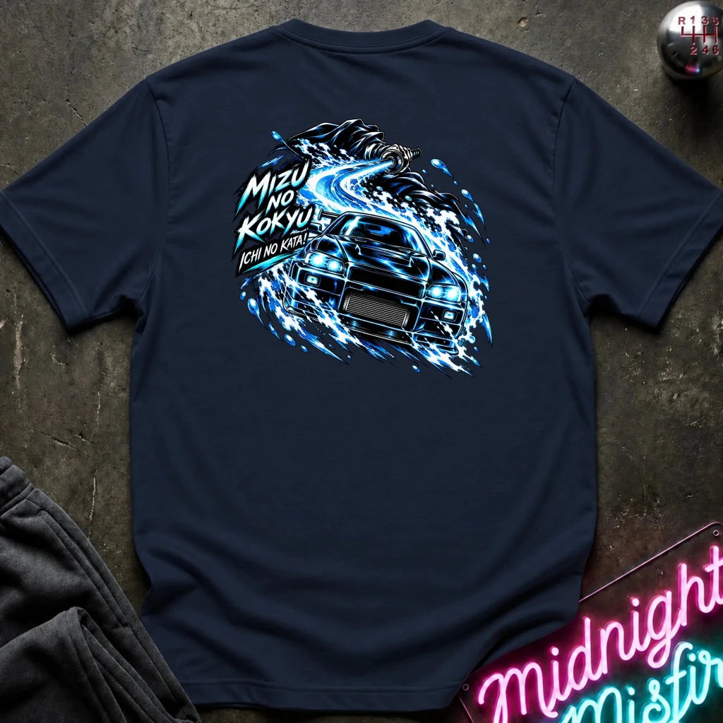 navy short-sleeve t-shirt laid flat on a dark textured surface, showing the back graphic with a car and the text "ichi no kata!"