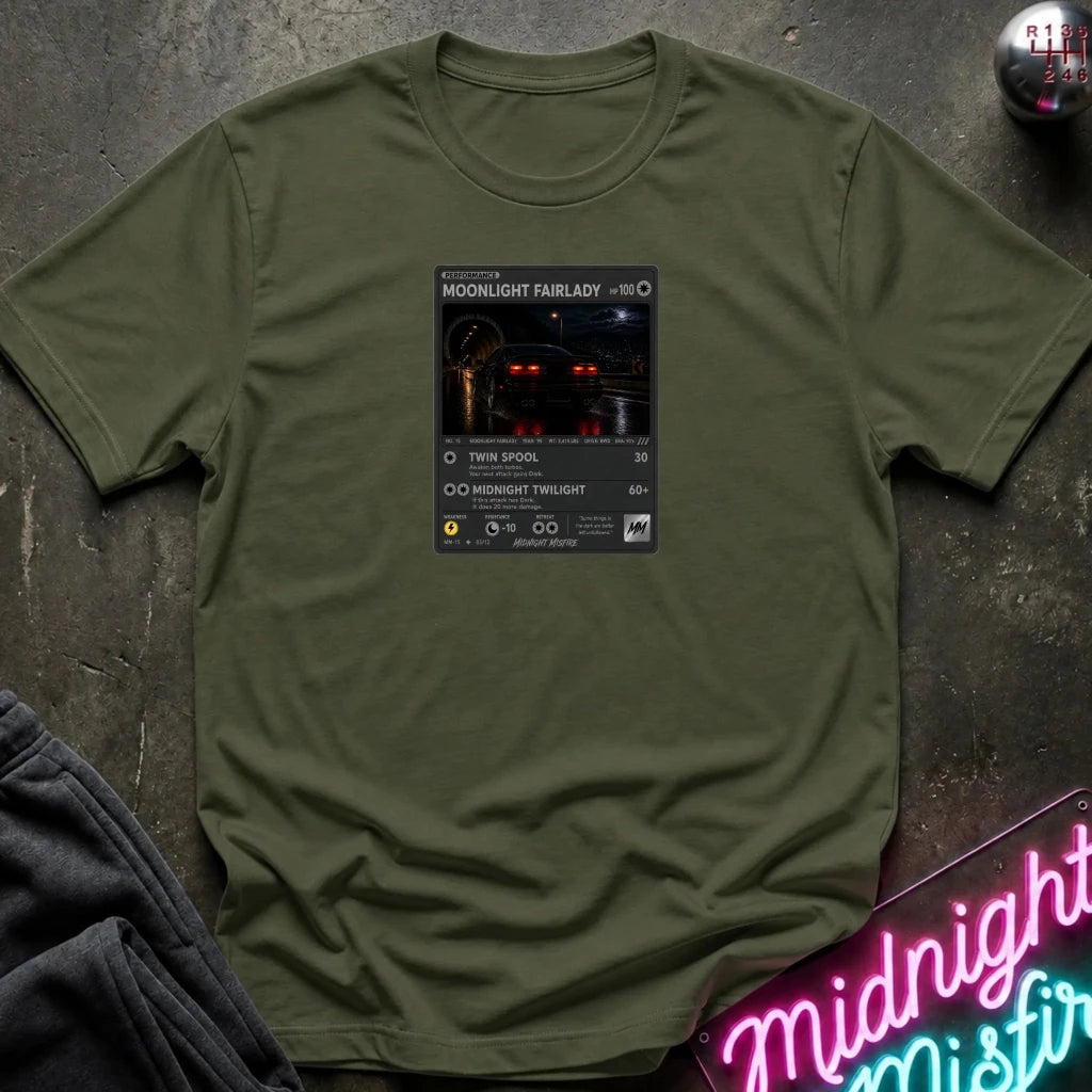 olive crewneck t-shirt laid flat on a dark textured surface, featuring a graphic print of vintage card and a car.