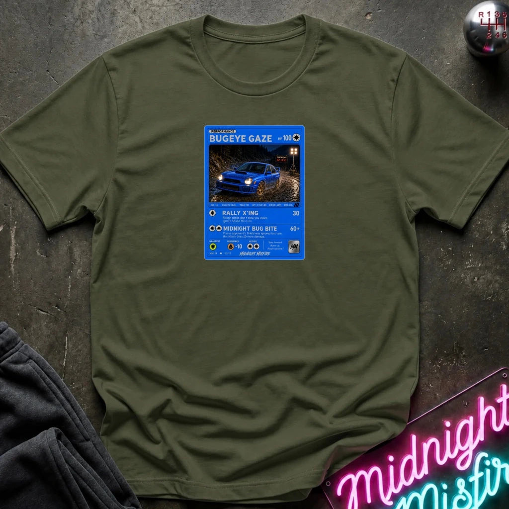 olive crewneck t-shirt laid flat on a dark textured surface, featuring a graphic print of vintage card and a car.