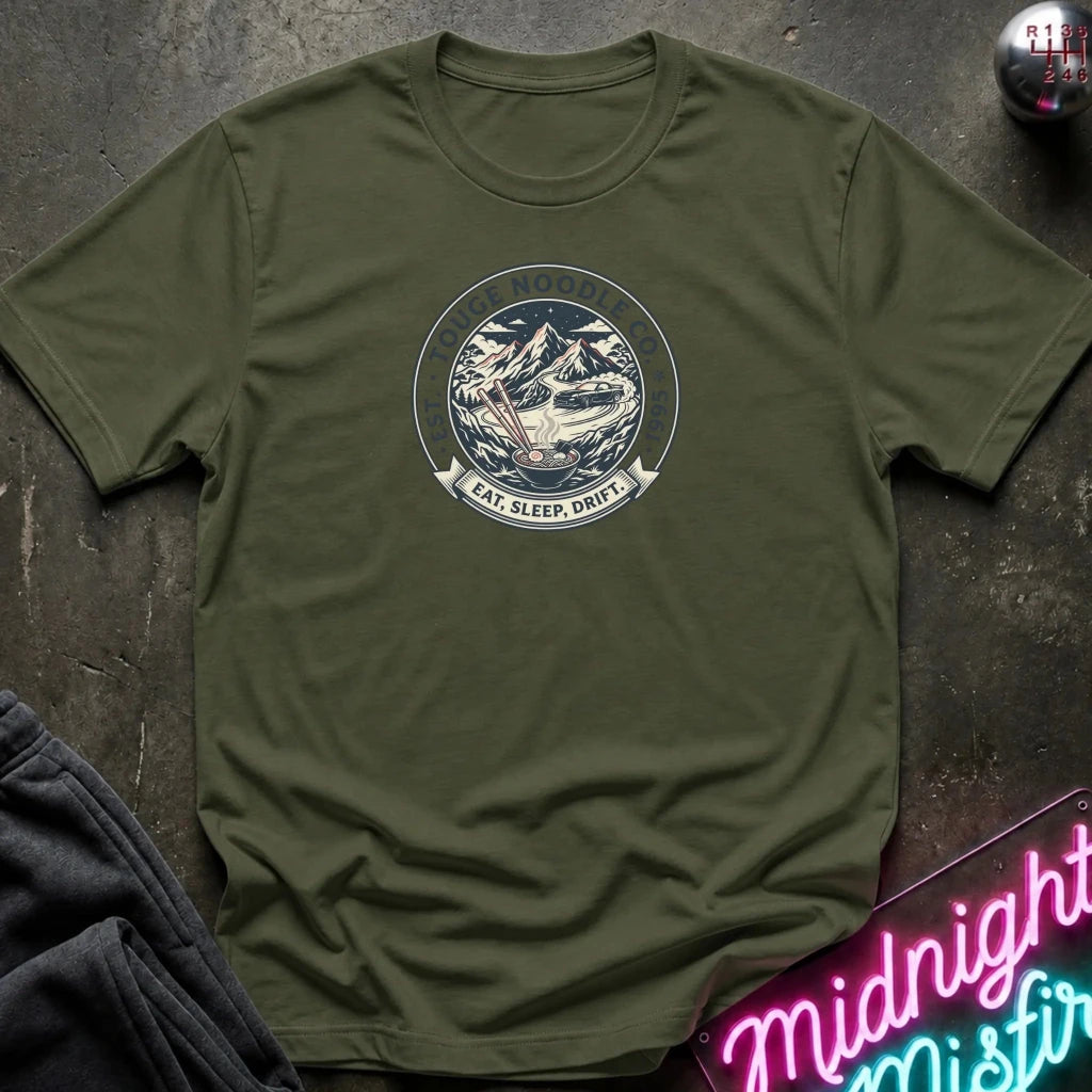 An olive green crewneck t-shirt with a circular mountain graphic on the chest 