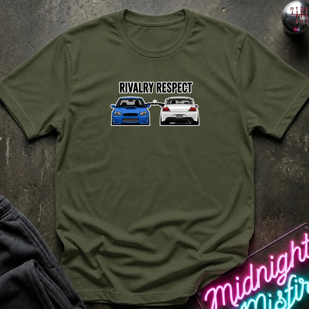 olive graphic t-shirt laid flat on a dark textured surface. The graphic features the text 'RIVALRY RESPECT' above a blue car facing a white car.