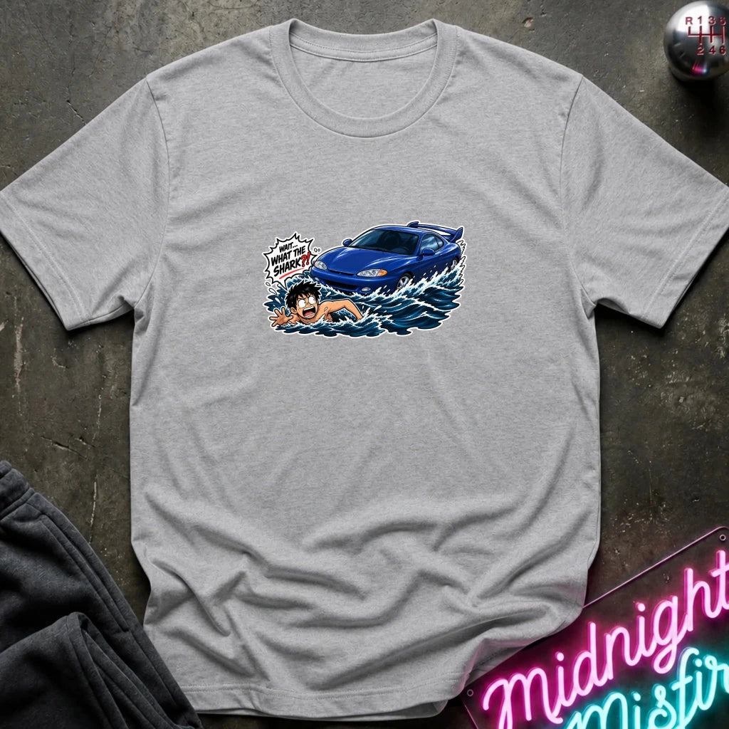 A gray short-sleeved t-shirt that has a blue car chasing a swimmer in open water.