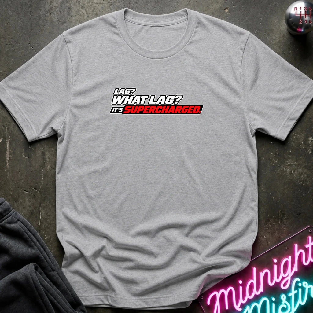 A light heather gray crewneck t-shirt with a graphic on the chest that reads 'LAG? WHAT LAG? IT'S SUPERCHARGED.' in white and red lettering.