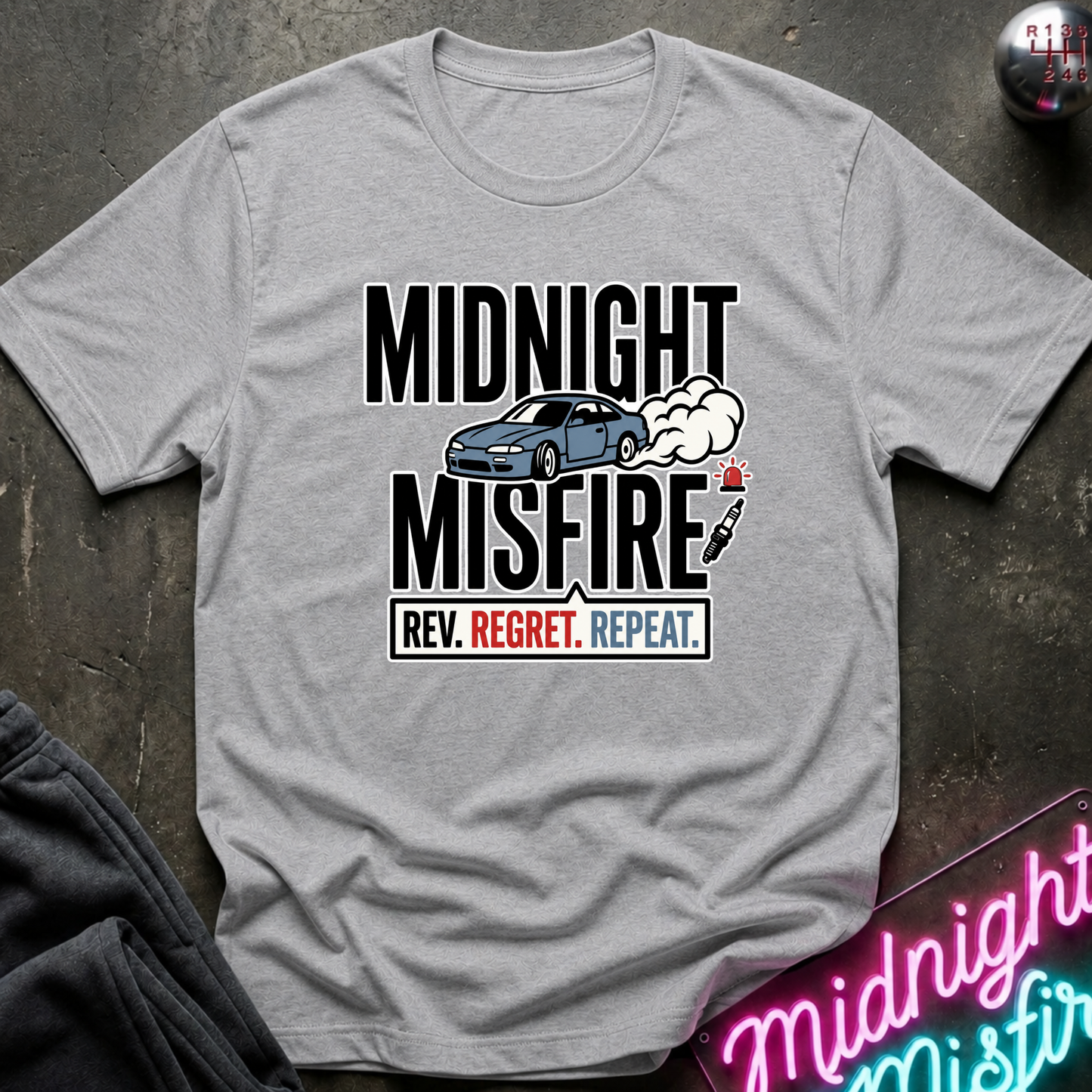 A light gray crewneck t-shirt with a graphic print that reads 'MIDNIGHT MISFIRE.
