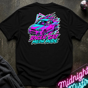A black short-sleeve graphic t-shirt laid flat on a dark textured surface. The back of the shirt features a colorful graphic of a pink and teal car with a cartoon cat inside, surrounded by neon-style geometric shapes and the text 'RACER CAT MEOW MODE' in bright pink, teal, and white.