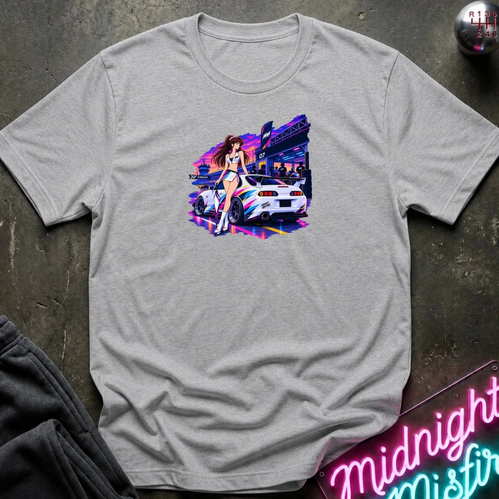 A light gray heather  short-sleeve t-shirt laid flat on a dark textured surface, featuring a colorful graphic print of a white sports car and a woman in a neon-lit scene. 
