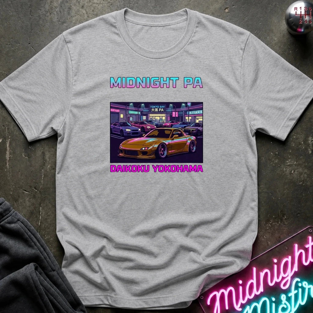 A light gray heather crewneck t-shirt featuring a graphic print of a yellow sports car in front of a neon-lit Japanese building, with the text 'MIDNIGHT PA' above and 'DAIKIDKU YOKOHAMA' below.