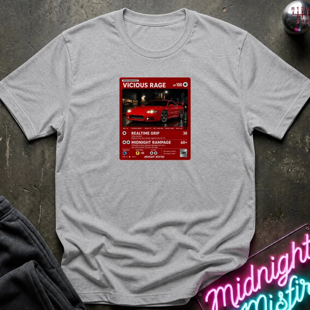 grey crewneck t-shirt laid flat on a dark textured surface. The shirt features a red rectangular graphic print in the center with a red sports car 