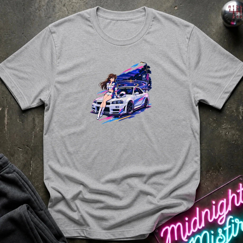 A light gray heather  short-sleeve t-shirt laid flat on a dark textured surface, featuring a colorful graphic print of a white sports car and a woman in a neon-lit scene. 