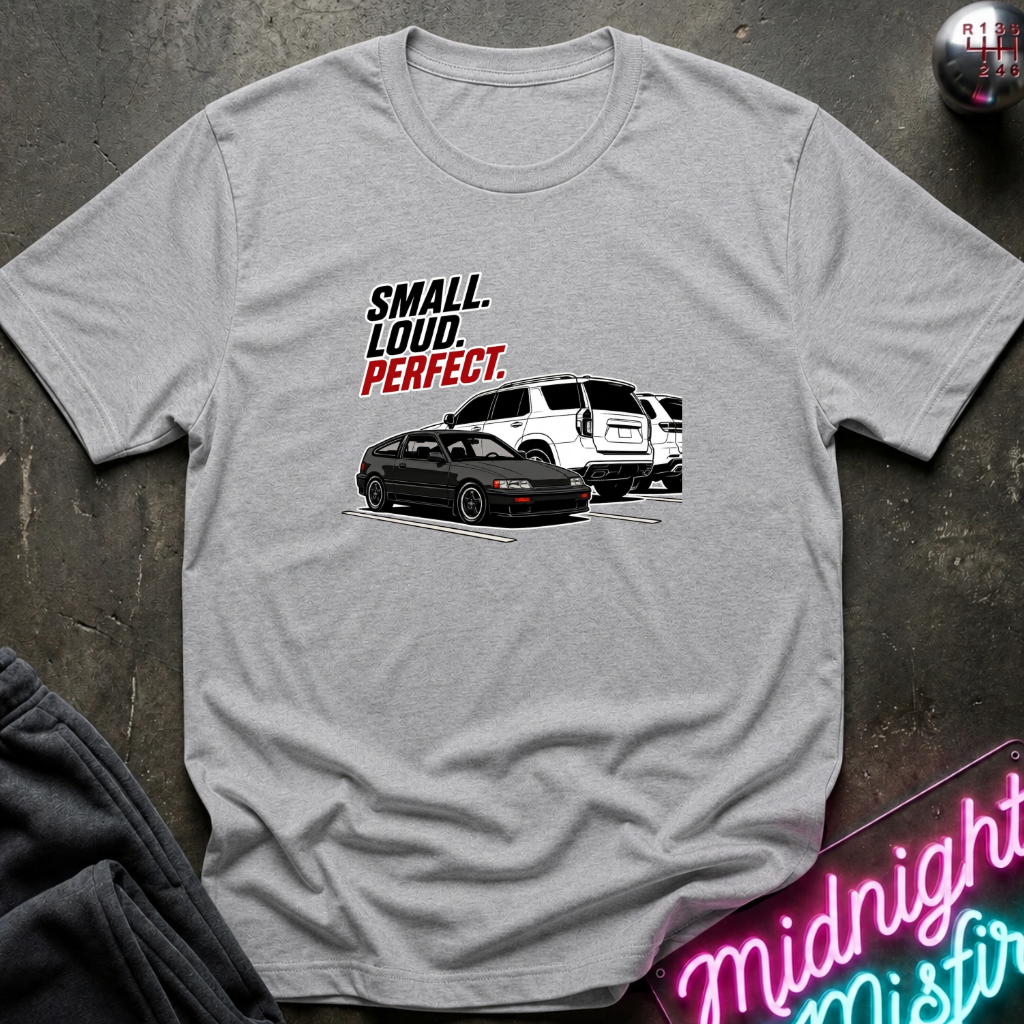 A light gray heather crewneck t-shirt featuring a graphic print of a black sports car and a white SUV with the text 'SMALL. LOUD.