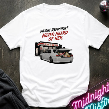 White short-sleeve graphic t-shirt laid flat on a dark textured surface. The graphic features the text 'WEIGHT REDUCTION? NEVER HEARD OF HER.
